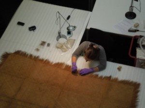 2nd year student Emma Schmitt conserving a plaited mat at the Pitt Rivers Museum. © Pitt rivers Museum, University of Oxford