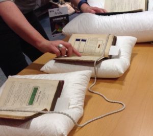 Anita in the University of Glasgow Special Collection showing dyeing manuals published in 1874 and 1882 with textile samples of early synthetic dyes.