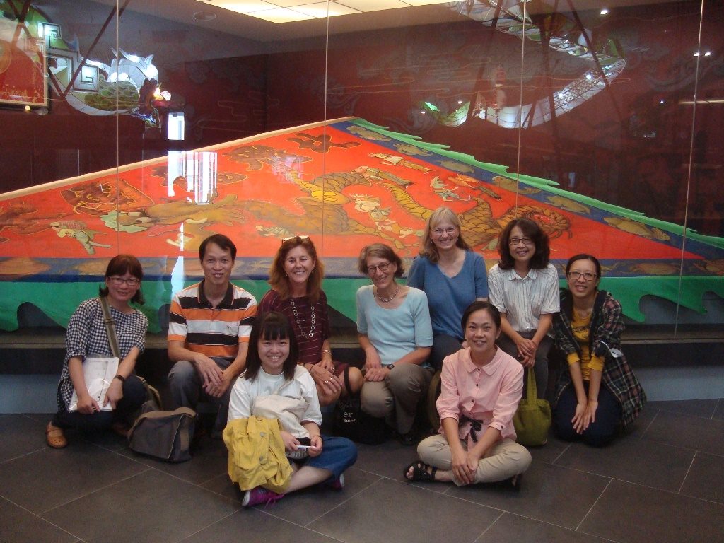 The team in front of the painted banner in the Beigang Cultural Centre